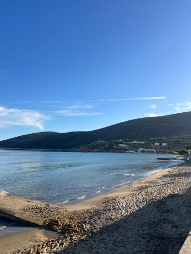 a beach with the ocean and mountains in the background at Petradi Residence Sifnos in Platis Yialos Sifnos