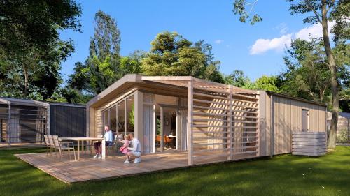 a family is standing on the deck of a tiny house at Cozy beach cottage Enkhuizen near the lake in Enkhuizen