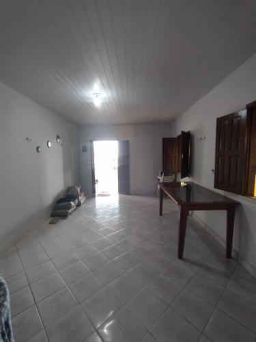 a living room with a table in the middle of a room at La Fortaleza Algodoal in Maracanã