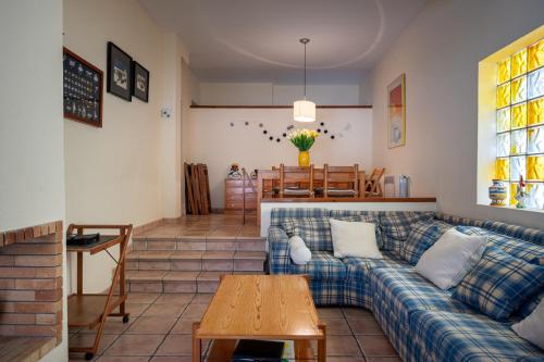 a living room with a couch and a table at At503 Ground floor & pool, beach 15min walk away in Comarruga