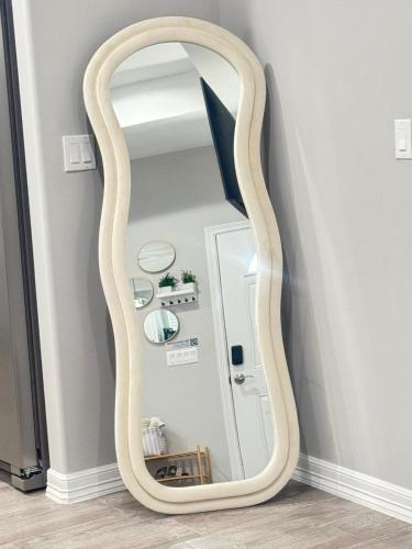 a wooden mirror in a corner of a room at Premier Luxe Villa in Weslaco
