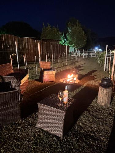 a patio with a table with two glasses and candles at Capanna del Vale - Refúgio & Degustação no Vale dos Vinhedos in Bento Gonçalves