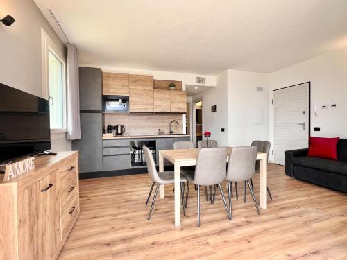 a kitchen and living room with a table and chairs at Costa Blu - Pool & terrace lake view in Riva di Solto