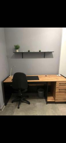 a desk with a chair and a laptop on it at Modern Grey in Néa Michanióna