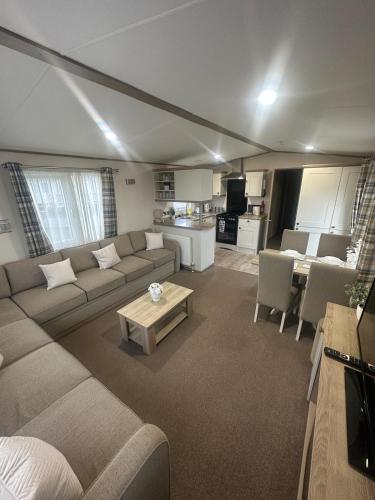 a living room with a couch and a table at 8 Birth Holiday Home in Selsey