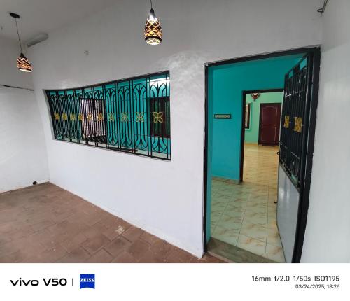 a hallway with a door and a painting on a wall at R & P Heritage Stay in Madurai