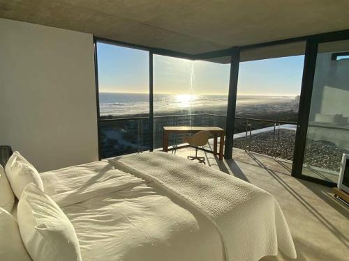 Ένα ή περισσότερα κρεβάτια σε δωμάτιο στο VAME Beach Front Bungalow