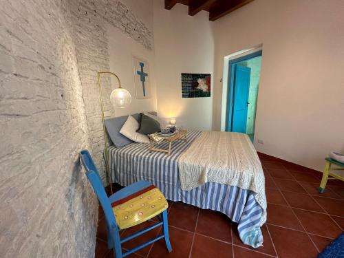 a bedroom with a bed and a table and a chair at La Gallinaia room with bathroom in Cartabubbo