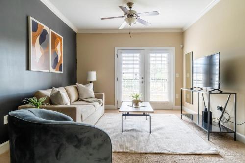 a living room with a couch and a tv at The Greensboro Vibe 8715 in Friendship