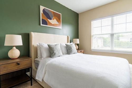 a bedroom with a white bed and a window at The Greensboro Vibe 8715 in Friendship