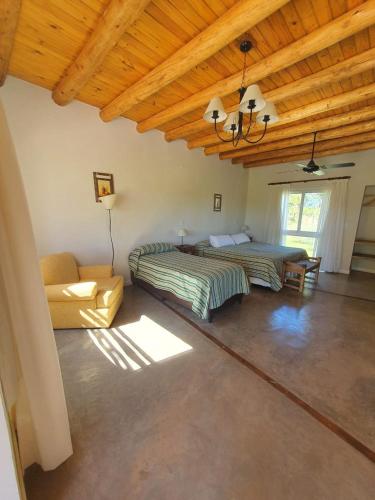 a room with two beds and a couch in it at Celestino Posta Andina in Barreal