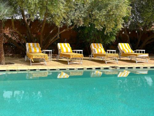 a group of chairs sitting next to a swimming pool at Palais Julia in Chouiter