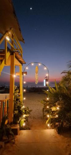 a view of a beach at night with a clock in a glass case at Mia's beach resort goa in Patnem