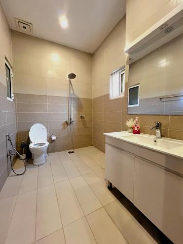 a bathroom with a toilet and a sink at Central City 2BHK by StayMehman in Rawalpindi