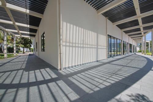 an empty hallway of a building with shadows on the ground at Nguyen Le Villa Long Hải in Long Hai