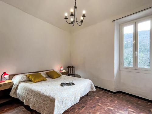 a bedroom with a bed and a window at Apartment Giove by Interhome in Valloria