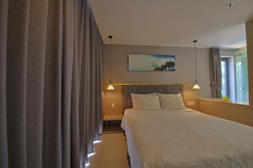 a hotel room with a bed and a window at Nguyen Le Villa Long Hải in Long Hai
