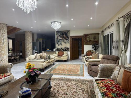 a large living room with couches and a chandelier at Villa 348 Jamaran - Sahl Hasheesh in Hurghada