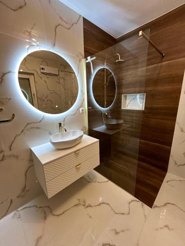 a bathroom with a sink and a mirror at Vila La Perla Istriana in Višnjan