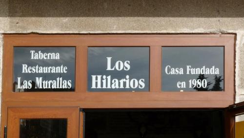 a glass door with words on the front of a building at Hotel Las Murallas in Avila