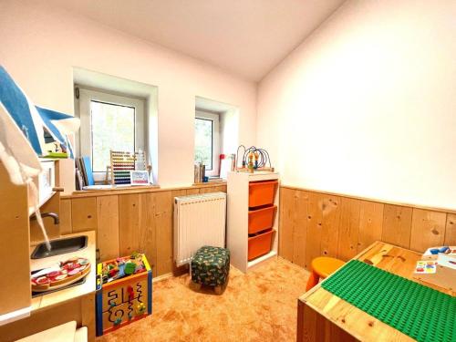a kitchen with wooden walls and a table in a room at Horská chata WALTEROVKA in Josefuv dul