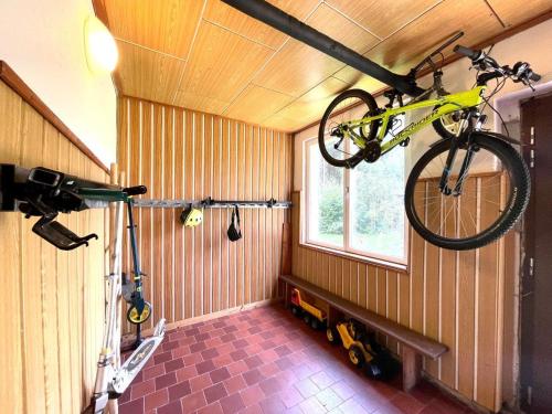 a bike hanging from the ceiling of a room at Horská chata WALTEROVKA in Josefuv dul