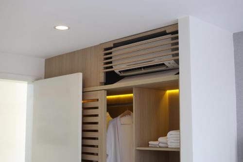 a walk in closet with a white robe in it at Nguyen Le Villa Long Hải in Long Hai