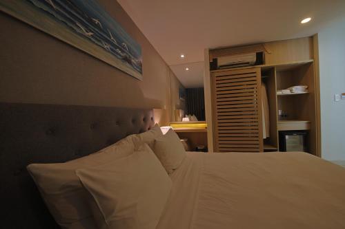 a bedroom with a large bed with white pillows at Nguyen Le Villa Long Hải in Long Hai