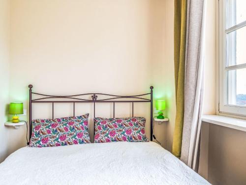 a bedroom with a bed with two pillows and a window at Apartment La Bordona by Interhome in Vignale Monferrato