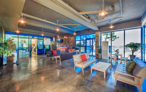 a large room with couches and tables and windows at Soleiview Spa Pension and Resort in Buan