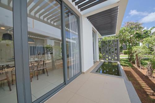 an external view of a house with a patio with a garden at Nguyen Le Villa Long Hải in Long Hai