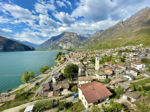a town next to a body of water with mountains at Apartment Martin Pescatore by Interhome in Verceia