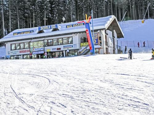 a building on a ski slope in the snow at Apartment Appartamento Carlotta by Interhome in Monclassico