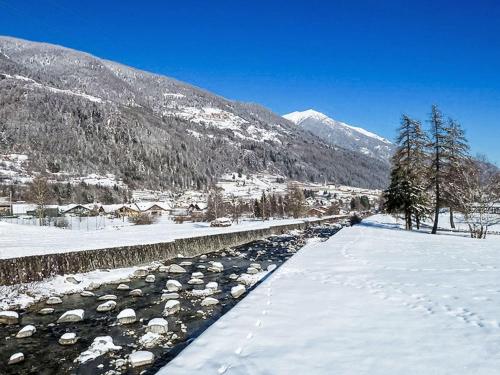 a river covered in snow next to a mountain at Apartment Appartamento Carlotta by Interhome in Monclassico