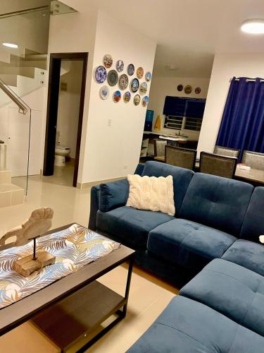 a living room with a blue couch and a table at New! Lovely and spacious, 2 Ocean view terraces in El Suazal
