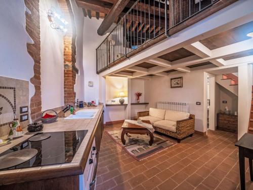 a kitchen with a living room with a couch at Apartment Nido-1 by Interhome in Panicale