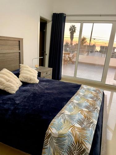 a bedroom with a bed with a view of a patio at New! Lovely and spacious, 2 Ocean view terraces in El Suazal