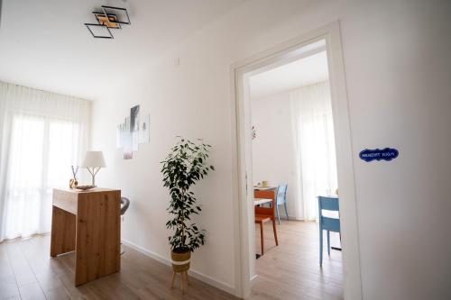 a living room with a plant and a table at Adriatic Sunrise B&B in Alba Adriatica
