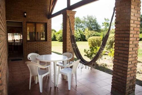 a patio with a white table and chairs at Rincón de los Sueños in Villa General Belgrano