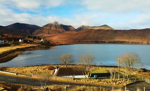 a view of a lake with mountains in the background at Katie Ann's Thatched Cottage in Luib
