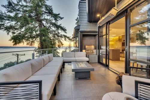 a living room with a couch and a table at The Sunset Lane Waterfront Home in West Vancouver