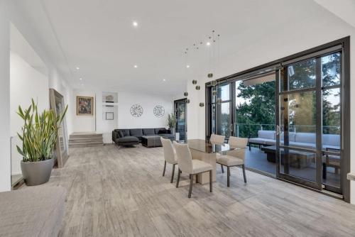 a living room with a table and chairs at The Sunset Lane Waterfront Home in West Vancouver