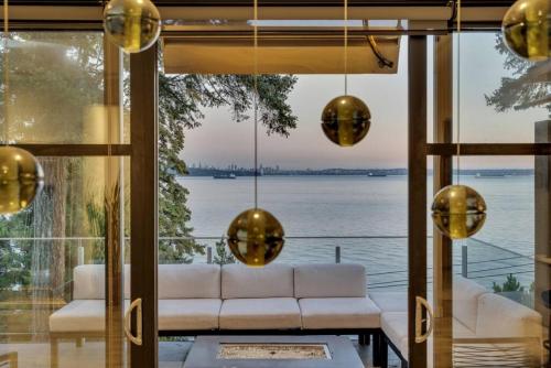 a living room with a view of the water at The Sunset Lane Waterfront Home in West Vancouver