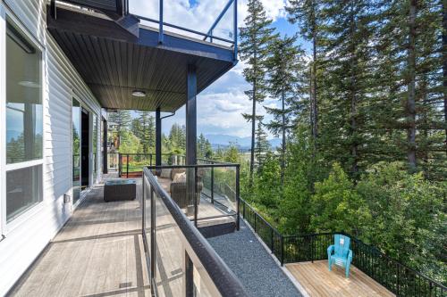 a balcony of a house with a view of trees at Stylish Retreat in Agassiz with Scenic Views in Agassiz