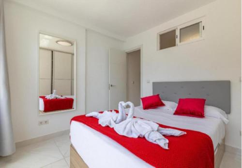 a bedroom with a bed with a towel on it at AH - Rayito II - Confort y diseño bajo el sol de Maspalomas in Maspalomas