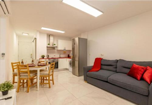 a living room with a couch and a table at AH - Rayito II - Confort y diseño bajo el sol de Maspalomas in Maspalomas