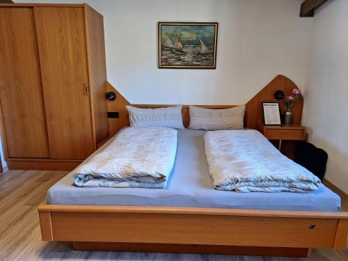 a bed with two pillows on it in a bedroom at Haus Sprenger in Häselgehr