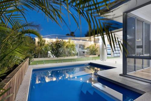 a swimming pool in the backyard of a house at MiaMia Ultra Modern Home with Pool and Courtyard in Perth