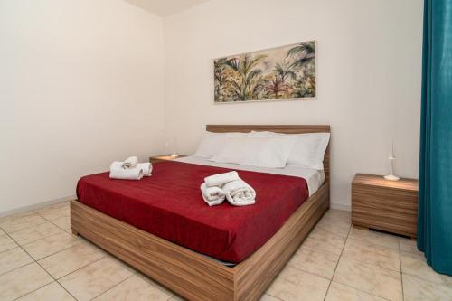 a bedroom with a bed with towels on it at Sea Residence LUNA ROSSA in Marzamemi