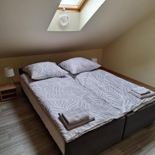 a bed with two pillows on it in a room at Apartament centrum Jura Żarki in Żarki